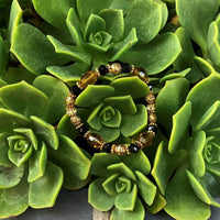 A bracelet made of Gold Barrel Crystals with black rondels and antique gold beads