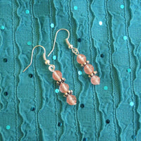 Earrings made of Small faceted cherry quartz rounds with silver accents