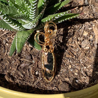 Pendant made of Ivory Copper Obsidian Oval stone with gold wire wrap; .5" w x 2" long, incl bail