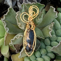 Pendant made of Ivory Copper Obsidian Oval stone with gold wire wrap; .5" w x 2" long, incl bail