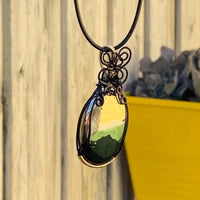 Pendant made of Large Apache Gold Pyrite Oval with Black and Gold wire wrap; 1: w x 2.25" long, incl bail. Come with 18" black cord with 2: extender