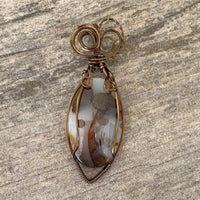 Pendant made of Large Polka Dot Jasper Oval stone with antique bronze wrap; 1" w x 2.75" long, incl bail