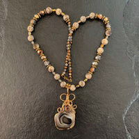 A necklace made of Grey Botswana Agate trimmed in gold with Jasper beads and crystals