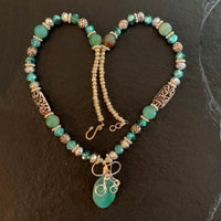 A necklace made of Aqua Fire Agates w/Silver & Turquoise crystals