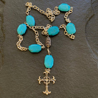 A necklace made of Turquoise Rectangles on silver chain with silver cross