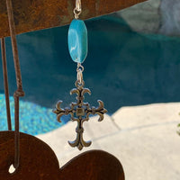 A necklace made of Turquoise Rectangles on silver chain with silver cross