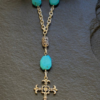A necklace made of Turquoise Rectangles on silver chain with silver cross