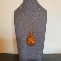 Pendant made of Large freeform Orange Carnelian w/ gold wrap; 1.5" x 2.5" incl bail