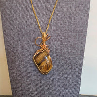Pendant made of Large Tiger Eye Nugget with gold wrap; 1" w x 2.5" h, incl bail