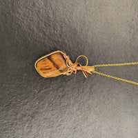 Pendant made of Large Tiger Eye Nugget with gold wrap; 1" w x 2.5" h, incl bail