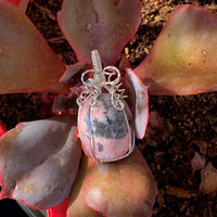 Pendant made of Pink & Grey Rhodonite oval stone with silver wrap; 1" w x 2" h incl bail