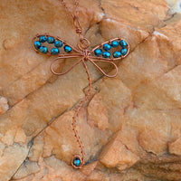 Pendant made of Dragonfly shaped copper wire with turquoise crystals; 2 1/8" w x 3 3/8" h incl bail