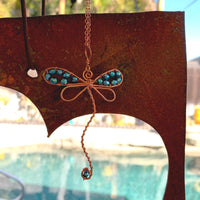 Pendant made of Dragonfly shaped copper wire with turquoise crystals; 2 1/8" w x 3 3/8" h incl bail