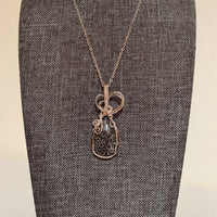 Pendant made of Natural Black Fossilized Coral stone with silver wrap; 7/8" w x 2" h, incl bail
