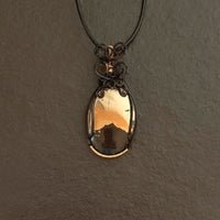 Pendant made of Large Apache Gold Pyrite Oval with Black and Gold wire wrap; 1: w x 2.25" long, incl bail. Come with 18" black cord with 2: extender