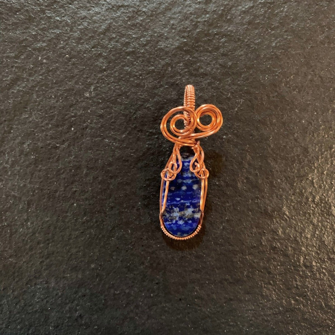 Pendant made of Lapis Lazuli Oval Pendant with copper wire wrap; 7/8" x 2 2 1/8" long, incl bail