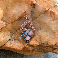 Mojave Turquoise Heart stone with Rose Gold & Antique Copper wire wrap; 1 1/8" w x 2 1/8" long incl bail This stone has been regarded as a power stone bringing protection from accidents and good fortune.