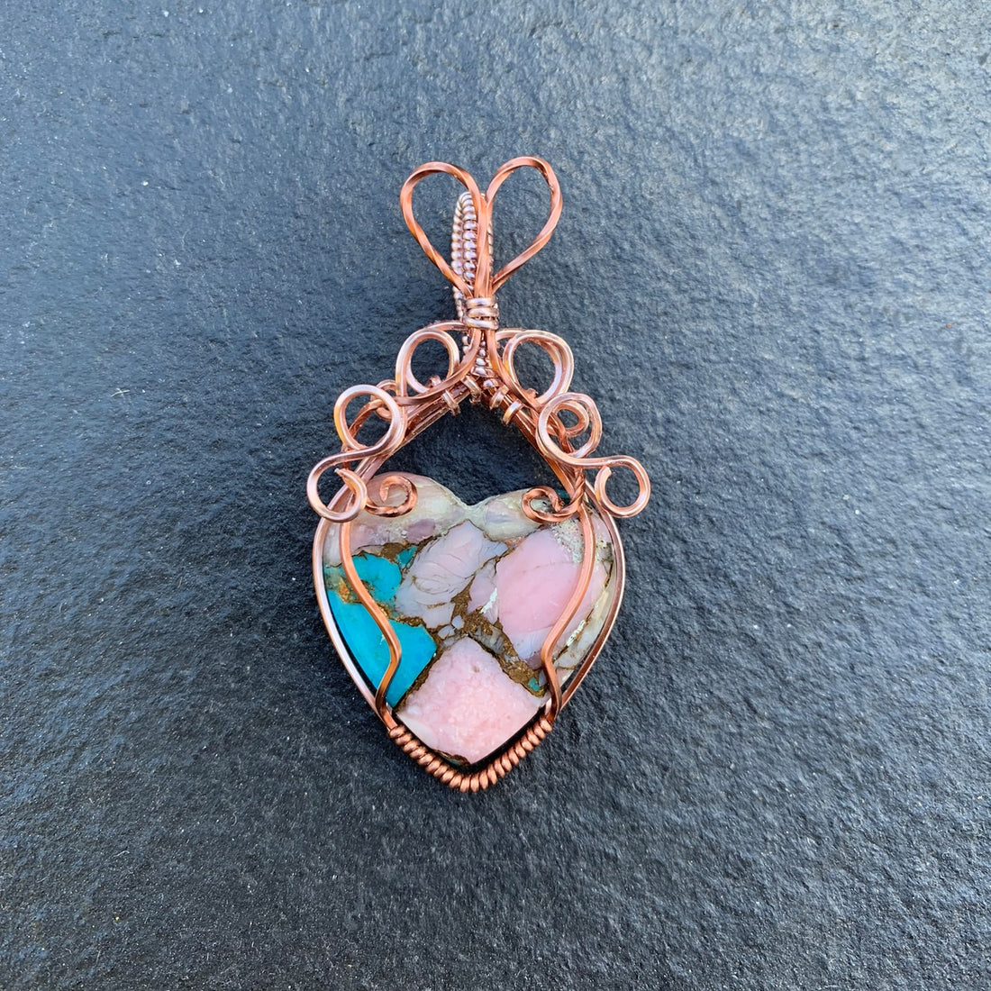 Mojave Turquoise Heart stone with Rose Gold & Antique Copper wire wrap; 1 1/8" w x 2 1/8" long incl bail  This stone has been regarded as a power stone bringing protection from accidents and good fortune.