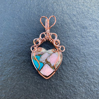 Mojave Turquoise Heart stone with Rose Gold & Antique Copper wire wrap; 1 1/8" w x 2 1/8" long incl bail This stone has been regarded as a power stone bringing protection from accidents and good fortune.