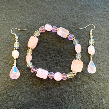 A jewelry set made of a matching rose quartz bracelet and rose quartz earrings.