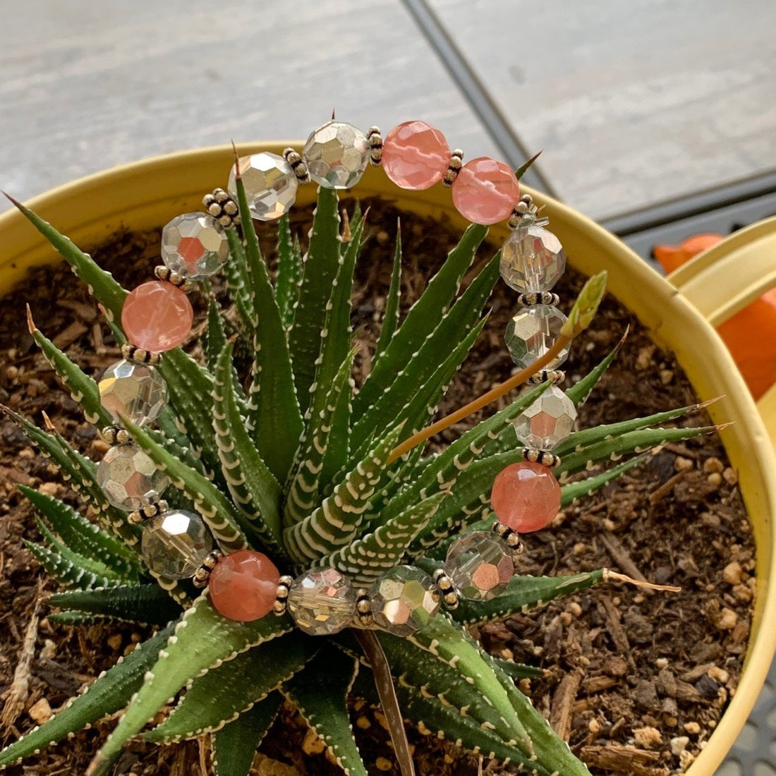 A bracelet made of cherry quartz rondels with silver crystals