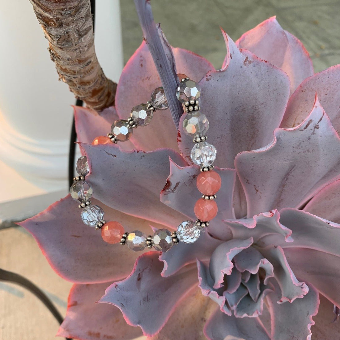 A bracelet made of cherry quartz rondels with silver crystals