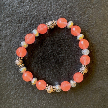 A bracelet made of Cherry Quartz faceted rounds with crystal rondels