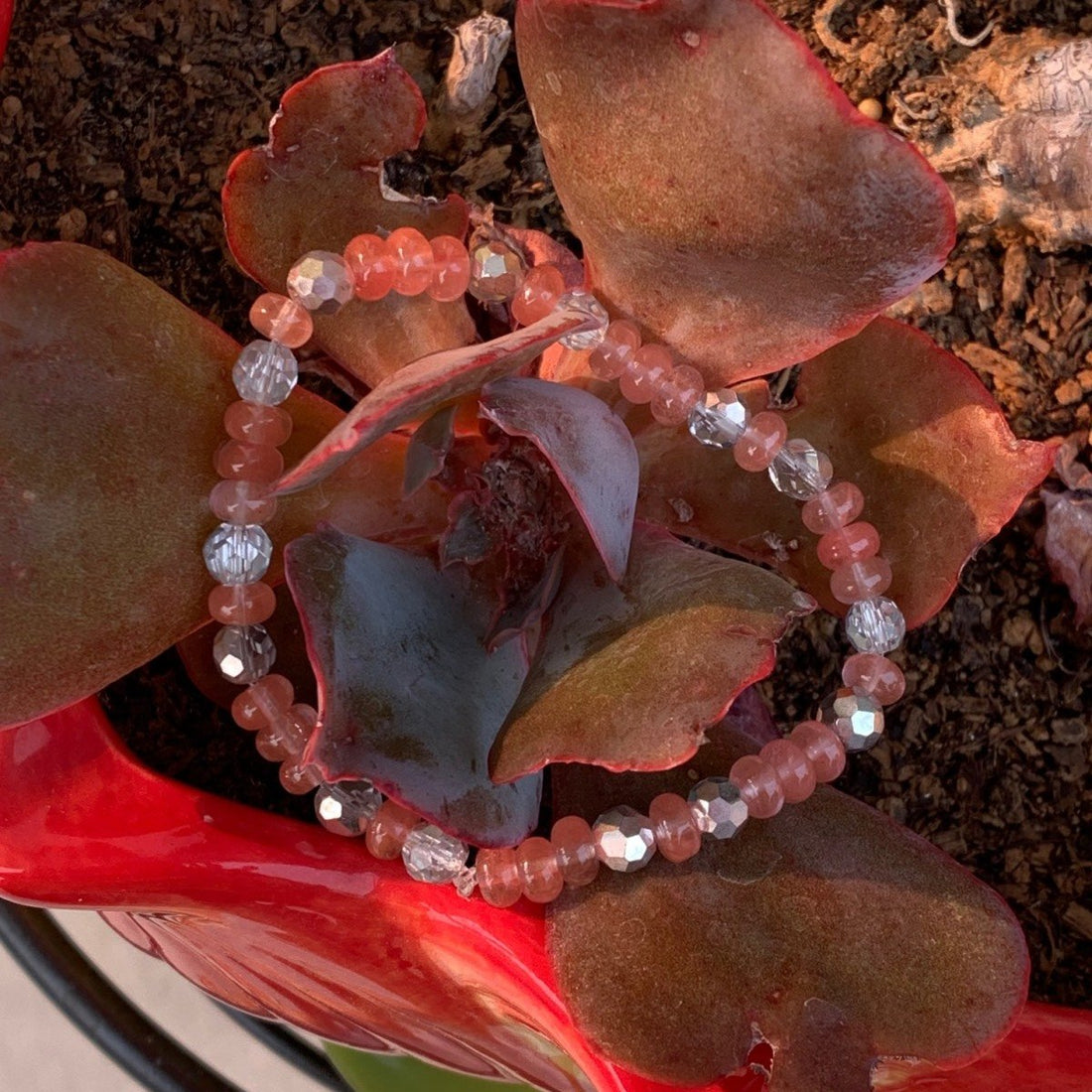 A bracelet made of Cherry Quartz rondels with silver crystals