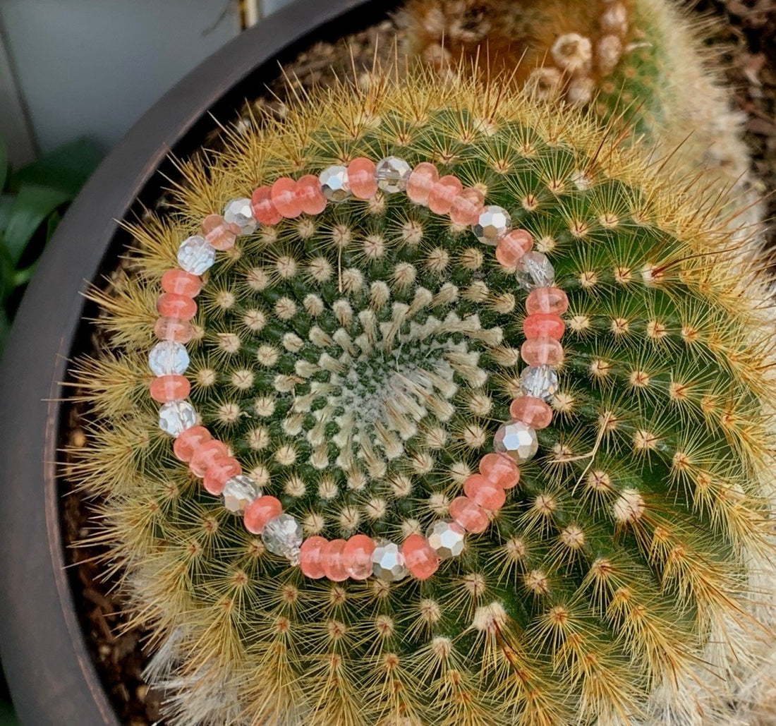 A bracelet made of Cherry Quartz rondels with silver crystals