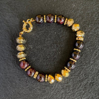 A bracelet made of Garnet beads & gold crystal rondels with magnetic clasp