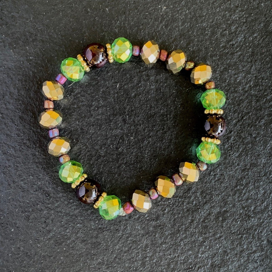 A bracelet made of Garnet beads, Green & gold rondel crystals on elastic