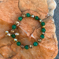 A bracelet made of Green Adventurine beads with gold pears, crystal & metal beads