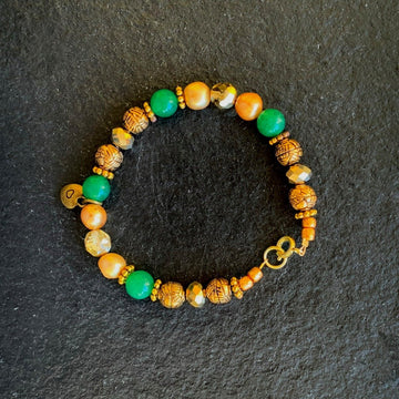 A bracelet made of Green adventurine beads with gold rondels & metal rounds