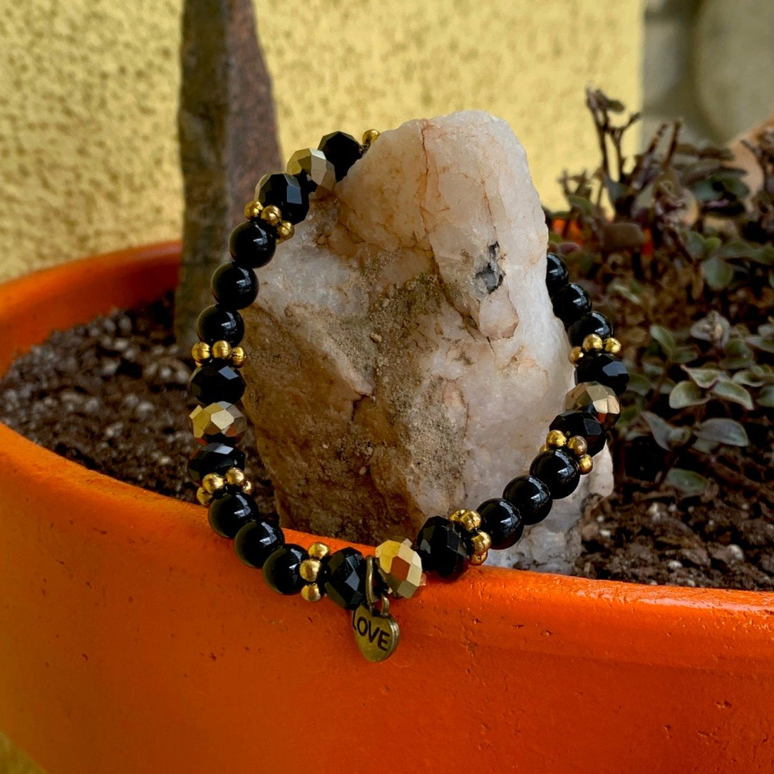 A bracelet made of Black onyx rounds with gold rondels