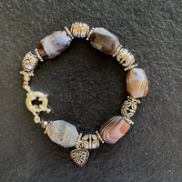 A bracelet made of Botswana faceted barrels with silver barrel beads and spring clasp