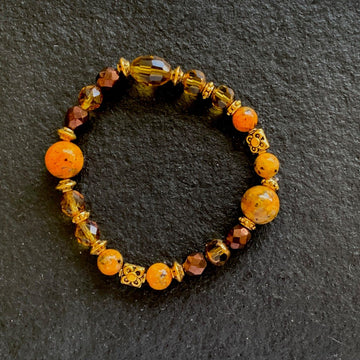 A bracelet made of Orange spotted Jasper w/bronze & gold crystals, metal spacers