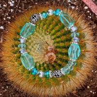 A bracelet made of Aqua Quartz rectangle barrels with silver crystals & beads