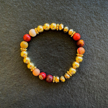 A bracelet made of Mookaite beads with gold beads & crystal rondels