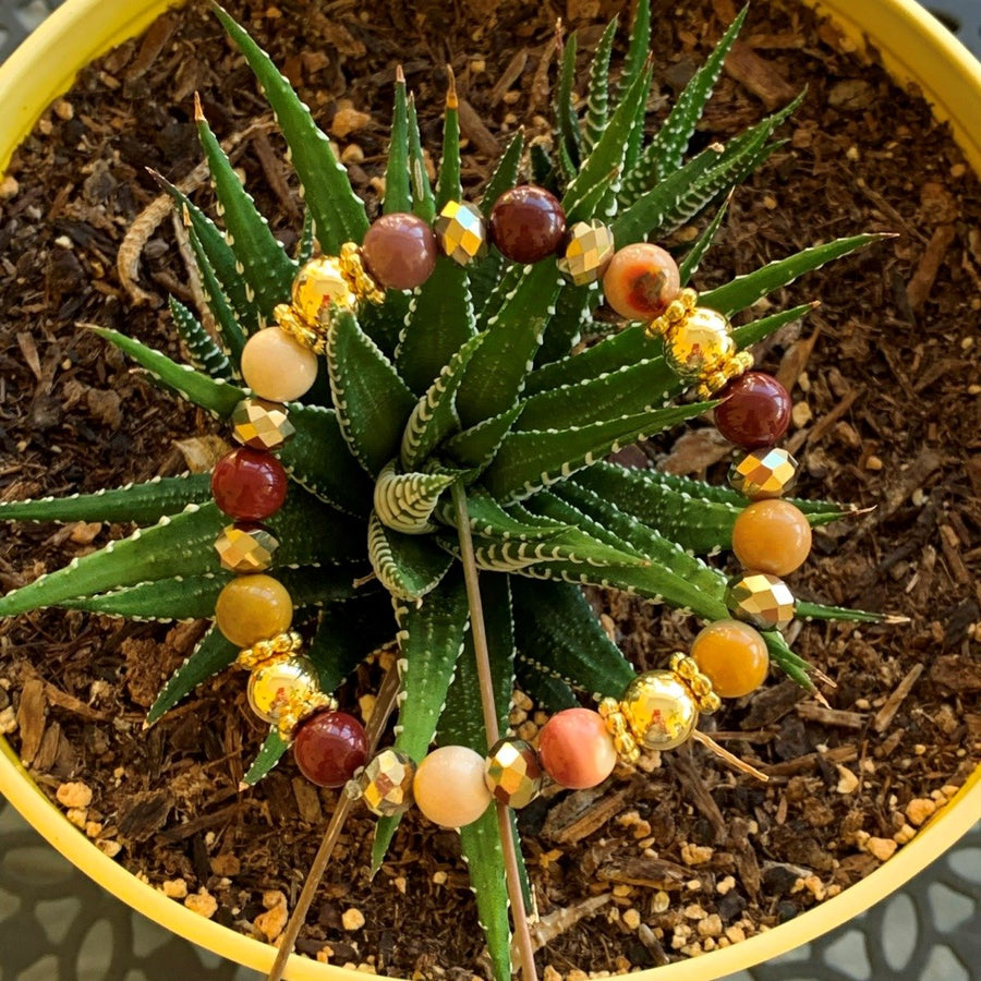 A bracelet made of Mookaite beads with gold beads and gold spacers