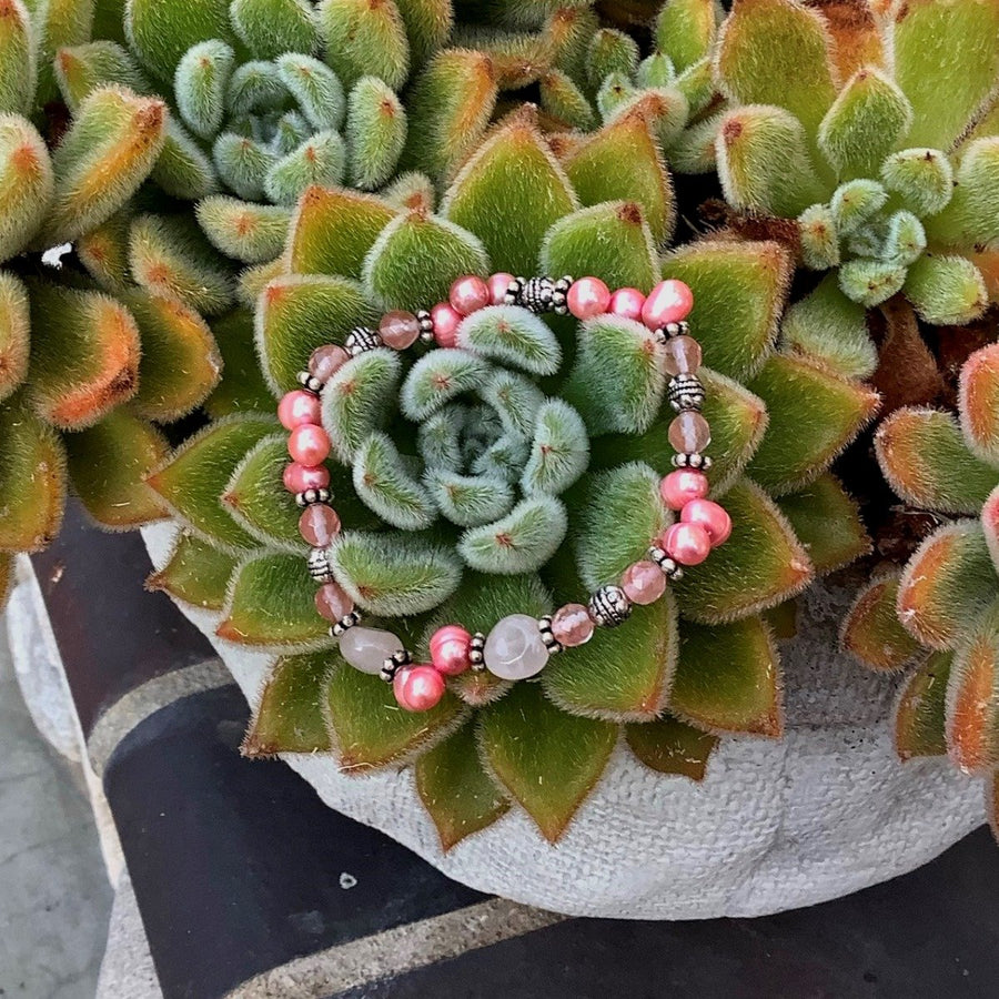 A bracelet made of Rose & Cherry Quartz with pink pearls and silver beads