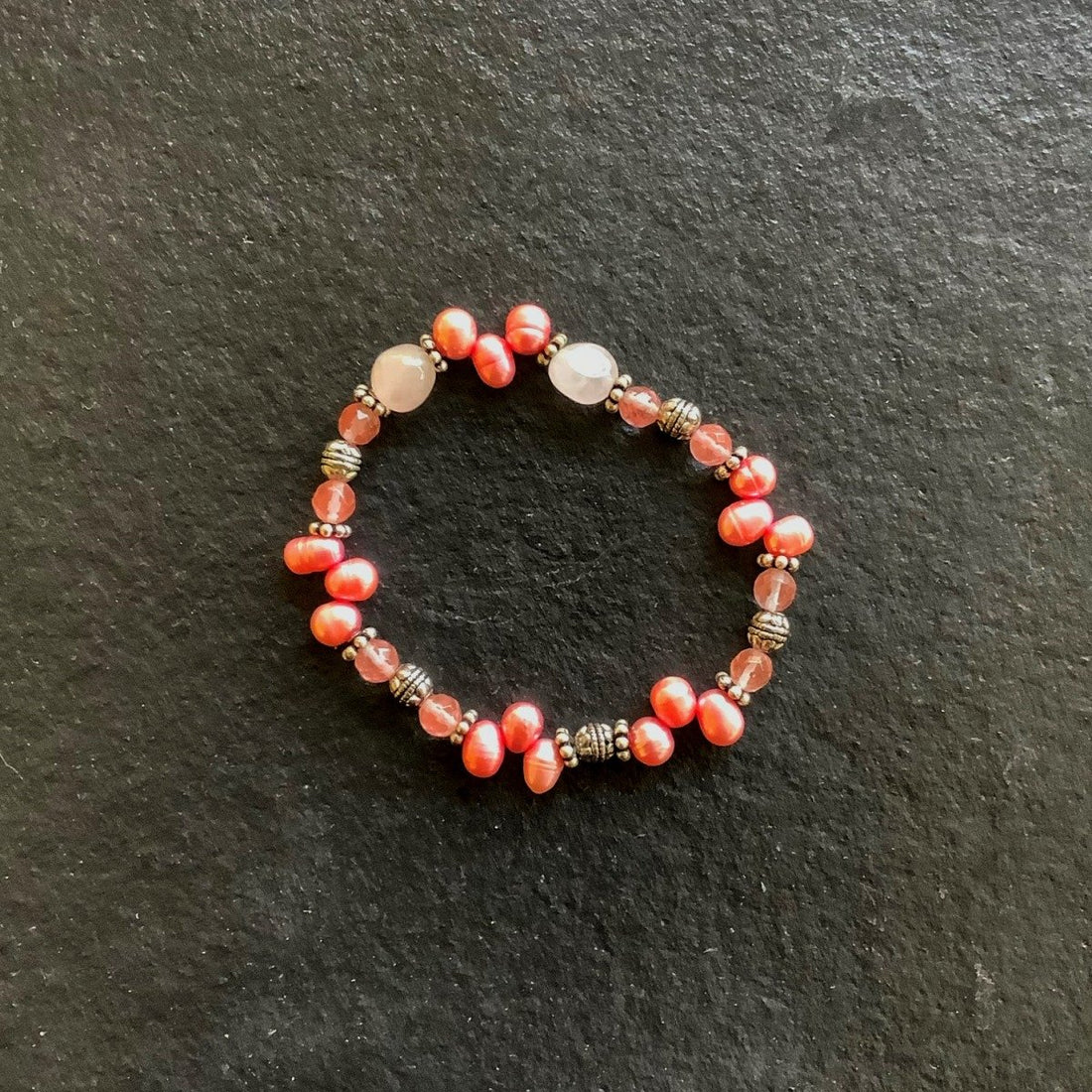 A bracelet made of Rose & Cherry Quartz with pink pearls and silver beads