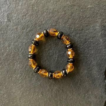 A bracelet made of Gold Crystal round with large black onyx rondels