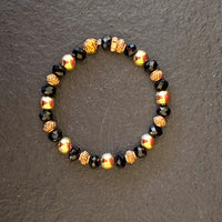 A bracelet made of Gold beads with black & gold rondels