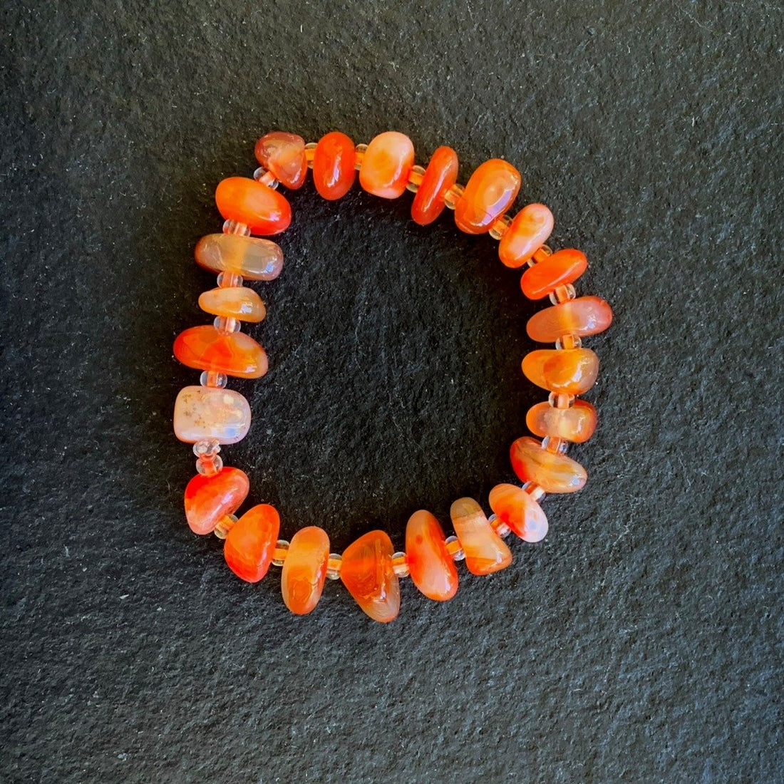 A bracelet made of Carnelian Chips with seed beads on elastic