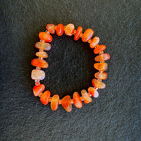 A bracelet made of Carnelian Chips with seed beads on elastic