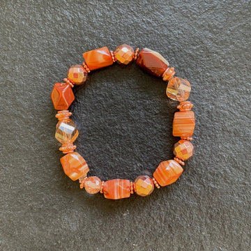 A bracelet made of Carnelian Nuggets with copper disco beads on elastic