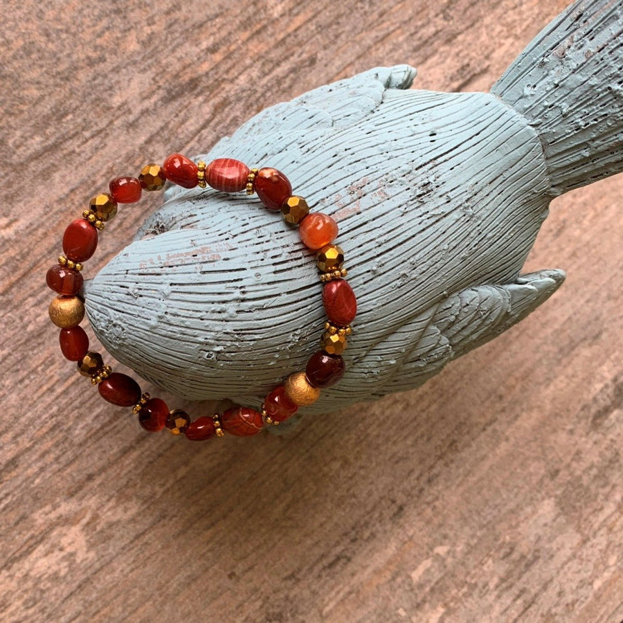 A bracelet made of Red Poppy Jasper ovals with Gold Florentine beads on elastic