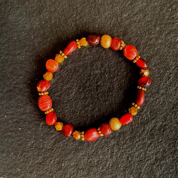 A bracelet made of Red Poppy Jasper ovals with Gold Florentine beads on elastic