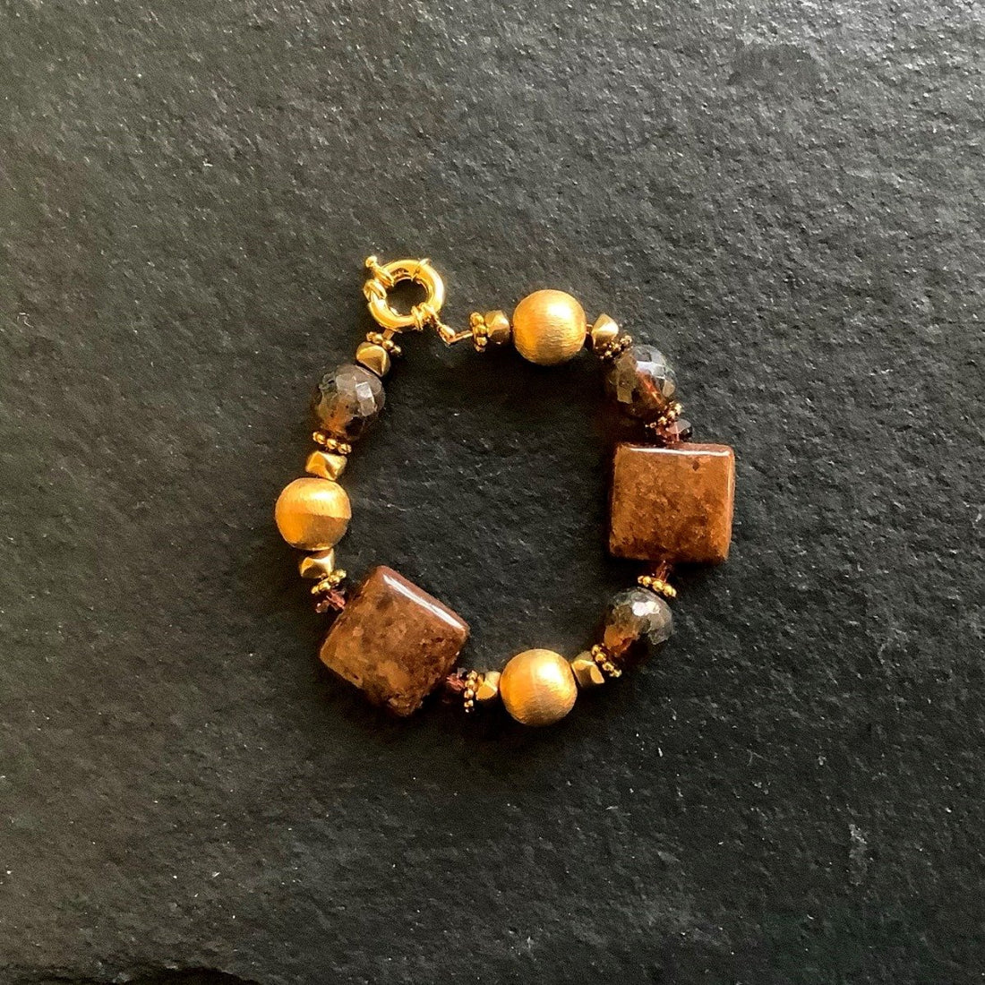 A bracelet made of Bronzite squares with florentine gold beads and spring clasp