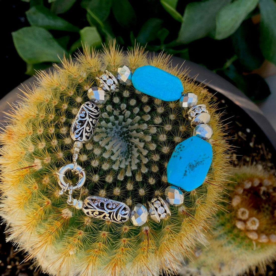 A bracelet made of Turquoise rectangles with silver crystals and antique silver beads with spring clasp